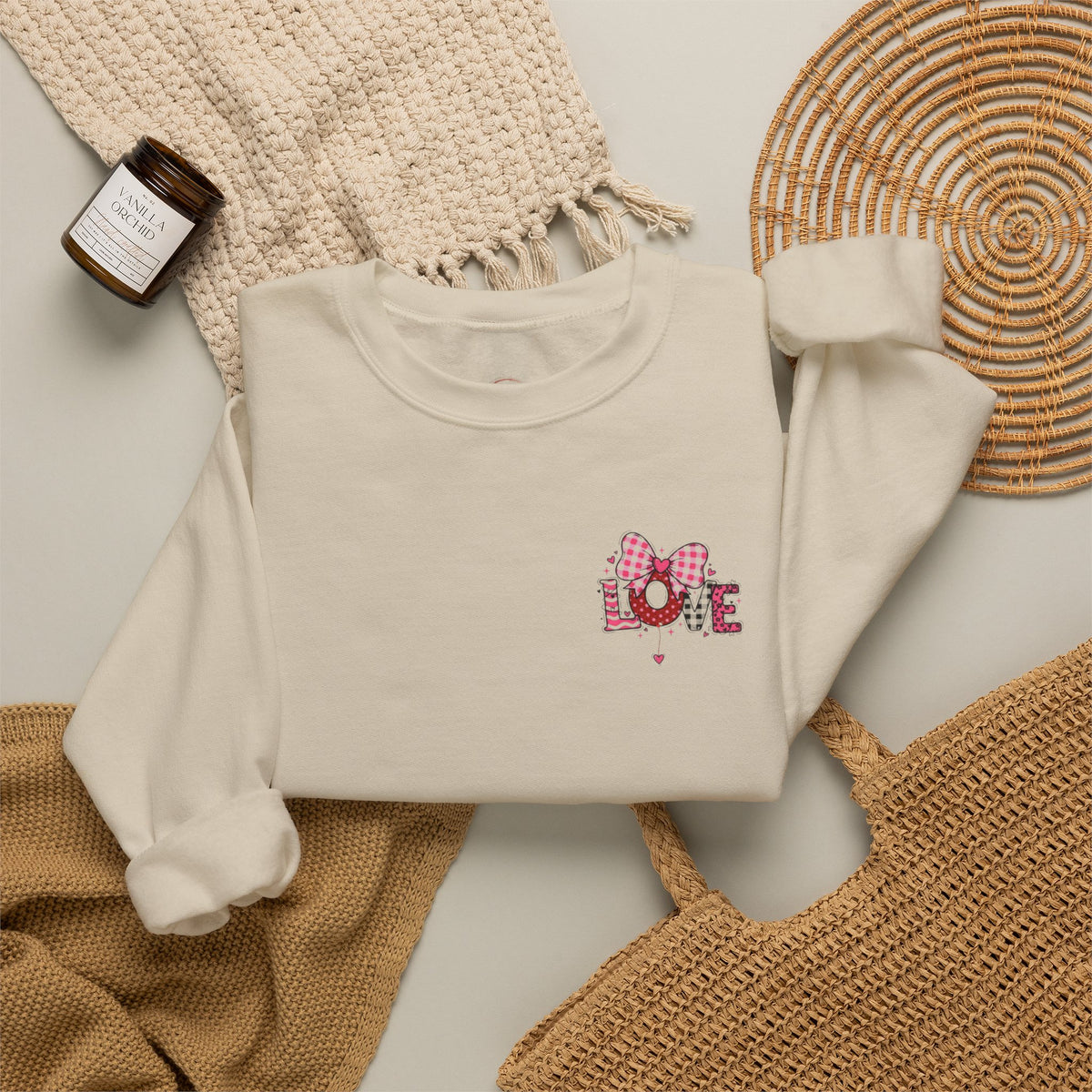 An off-white crewneck sweatshirt with a colorful cartoon graphic 