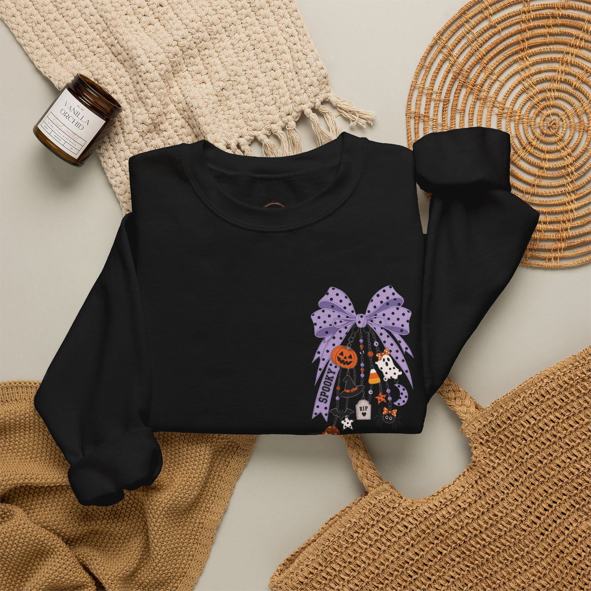 Black sweatshirt with a printed design on a textured surface