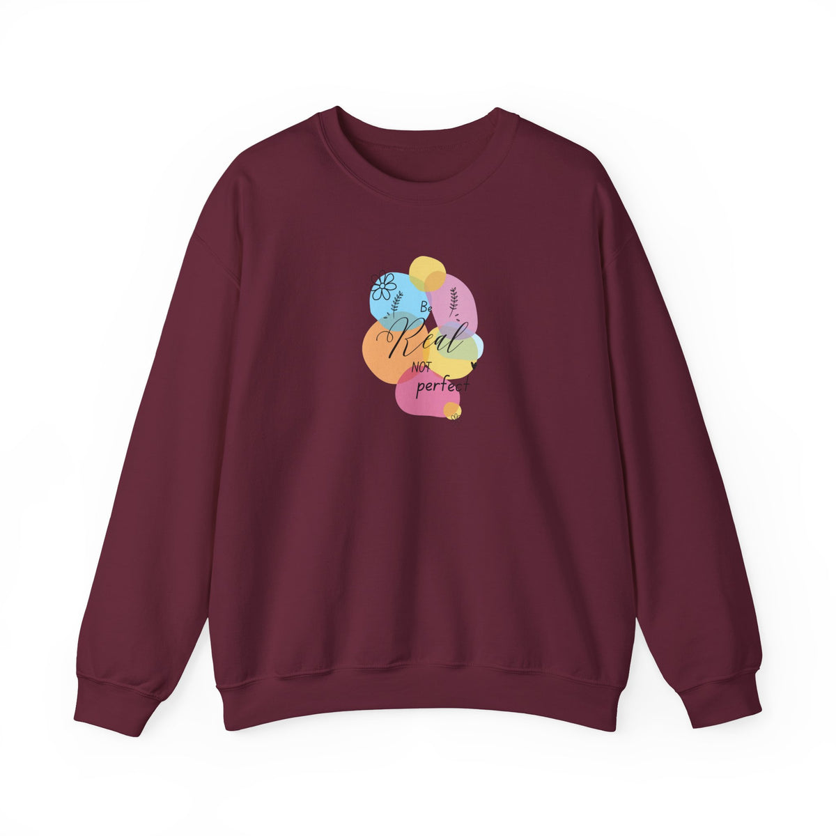 A maroon crewneck sweatshirt featuring a colorful graphic on the chest with overlapping pastel shapes and the text 'Kind is perfect'.